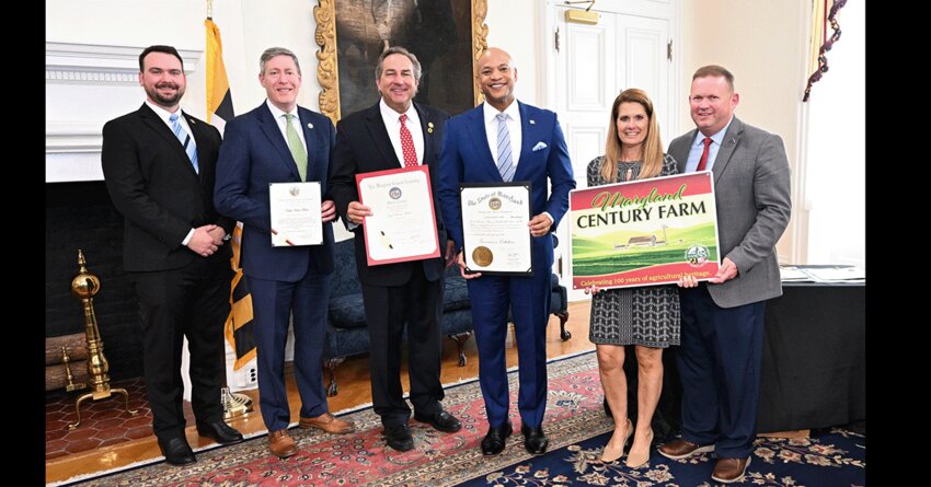 Tina and Milt Nagel, right, receive a Maryland Century Farm sign during an April 3 ceremony in Annapolis. With them are, from left, Harrison Palmer, executive secretary of the Maryland Agriculture Commission; Maryland Department of Agriculture Secretary Kevin Atticks; Sen. Johnny Mautz and Gov. Wes Moore.