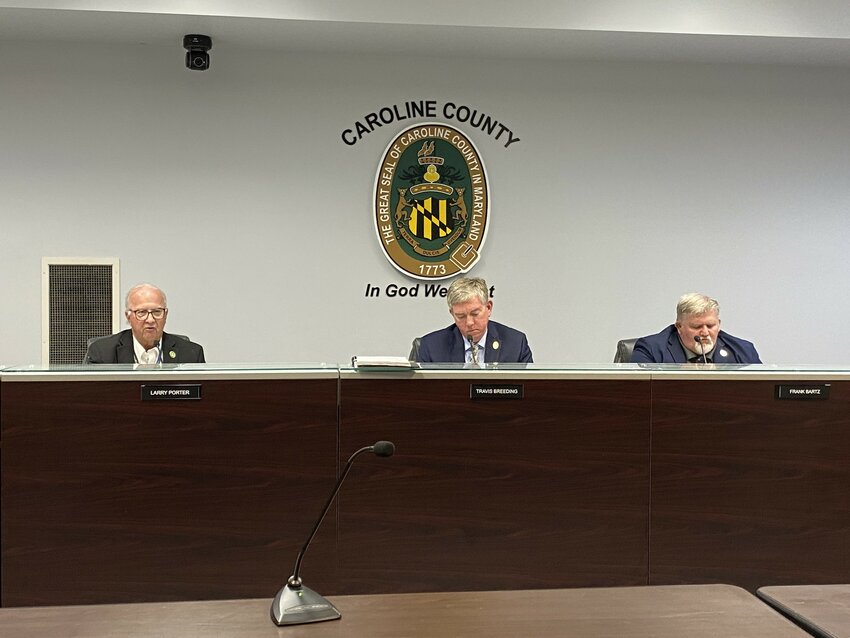 Caroline County Commission Vice President Larry Porter, left, addresses attendees of the May 6 budget public hearing, with President Travis Breeding, center, and Commissioner Frank Bartz.