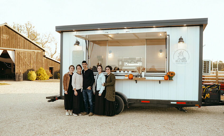 The By Faith Coffee team, from left, Alexa Good, owners Destiny and Delvin Horst, Lauren Horst, and Lindsay Halteman stand in front of tne custom-made mobile coffee trailer.