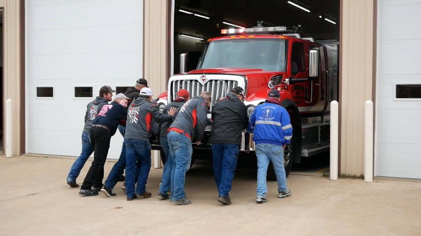Cashton’s fire crew push the new fire engine into service.