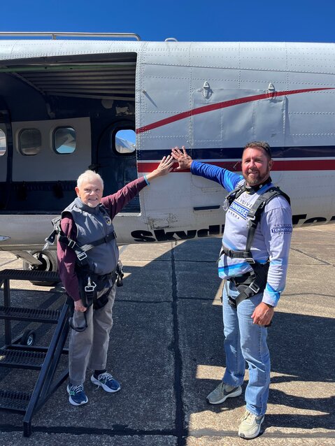 State Senator Ken Yager, R-Kingston, (left) and Mike Leventhal of Tennessee Men’s Health Network  touch the airplane they jumped out of on October 7, 2024.