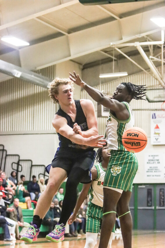 Hunter McLemore throws the ball around a defender for a pass Friday night. 