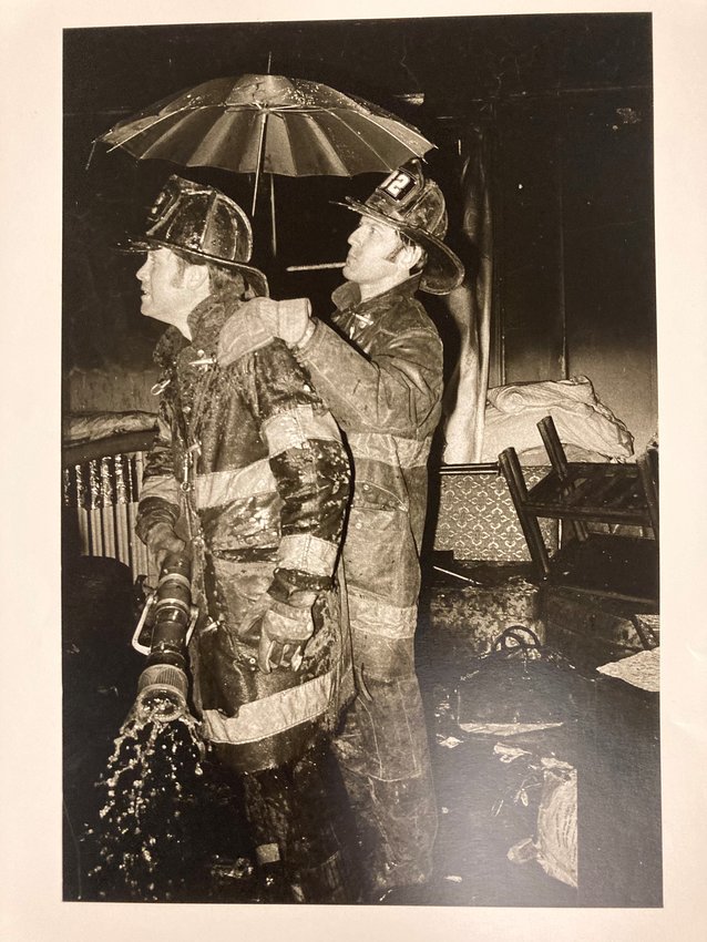 Engine 82 nozzleman and back-up man. Freedman otherwise captioned the picture “keeping dry on a cold night."