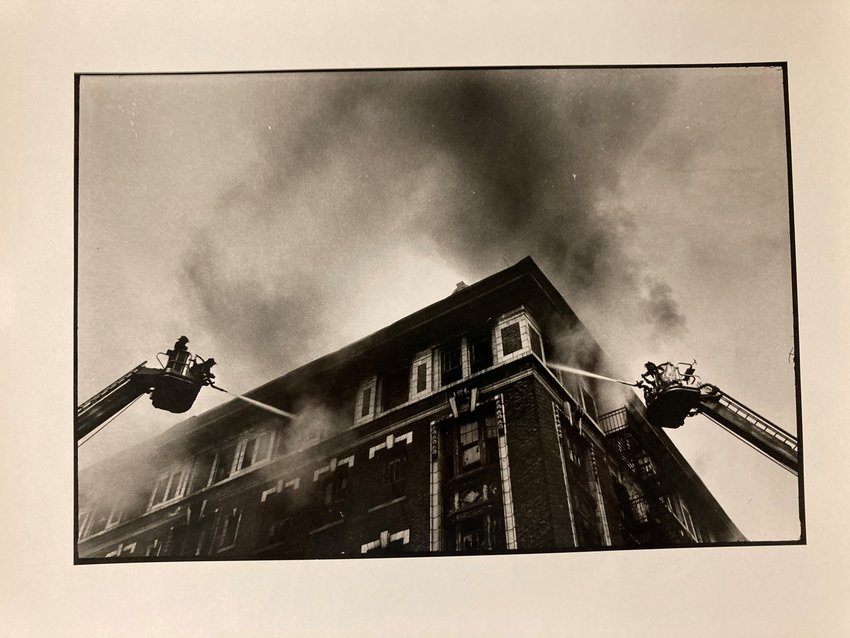 Freedman captioned this picture, "TOWER LADDERS. Applying tons of water to fully involved vacant six story tenement."