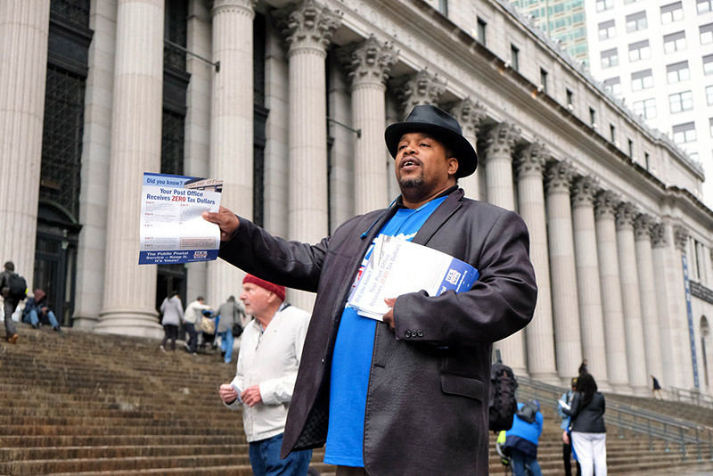 A SPECIAL DELIVERY: As members of the public flocked to the Farley Post Office to pay their taxes on the final day to file, Metro Area Postal Union President Jonathan Smith led his members in trying to convey a message that draws closer to being urgent: that the Trump Administration is seeking to reduce postal services to build a case ‘to privatize the post office so big business and their greed can get control.’ 