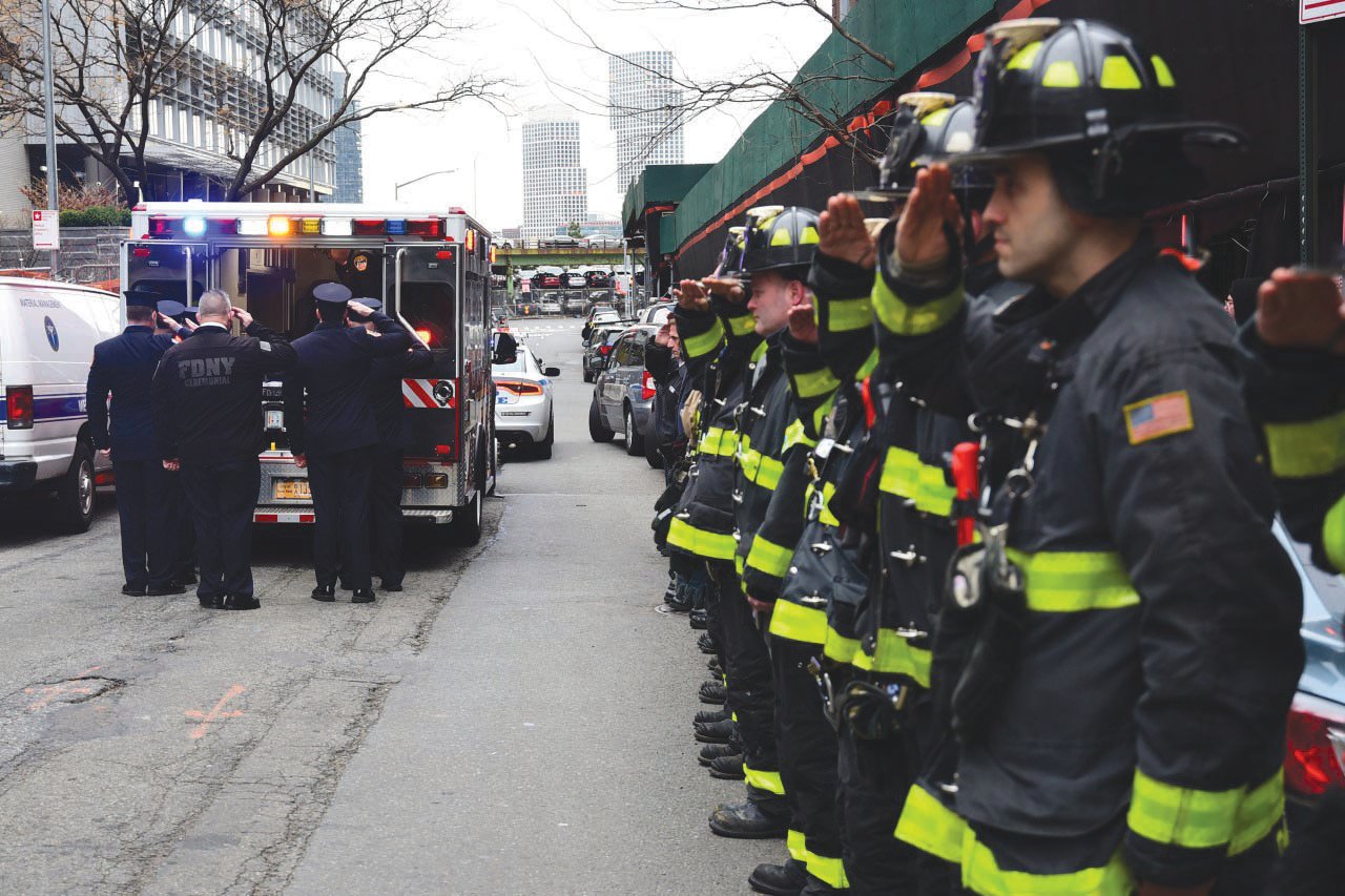 Firefighters from Engine 163 and Ladder 83 in Staten Island give a farewell salute to FDNY Lt. Joseph Maiello, who was found unconscious and pronounced dead while on-duty at the firehouse Dec. 26. His death and those of four other firefighters since December has prompted fire union officials to demand that the department explore any possible links to Covid. .