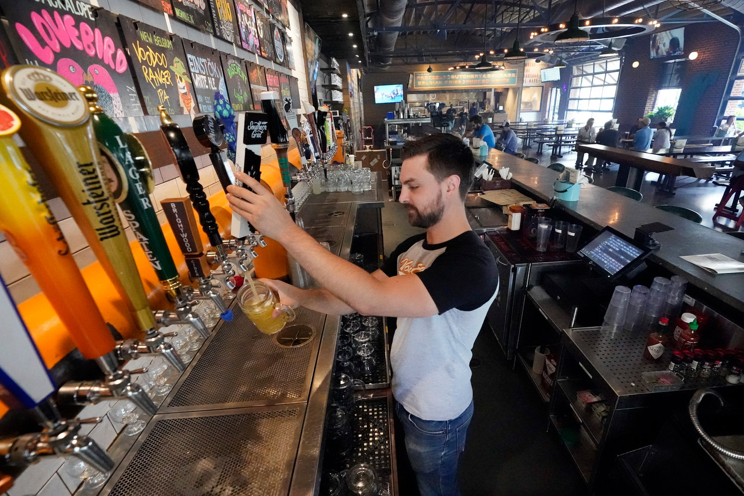 Andrew Kravchenko drew a beer at Von Elrod's Beer Hall And Kitchen in Nashville, Tenn., last week. For the restaurant, located across the street from Nashville's minor league baseball stadium that sees big crowds in the summer, both inflation and the worker shortage have sent costs skyrocketing.
