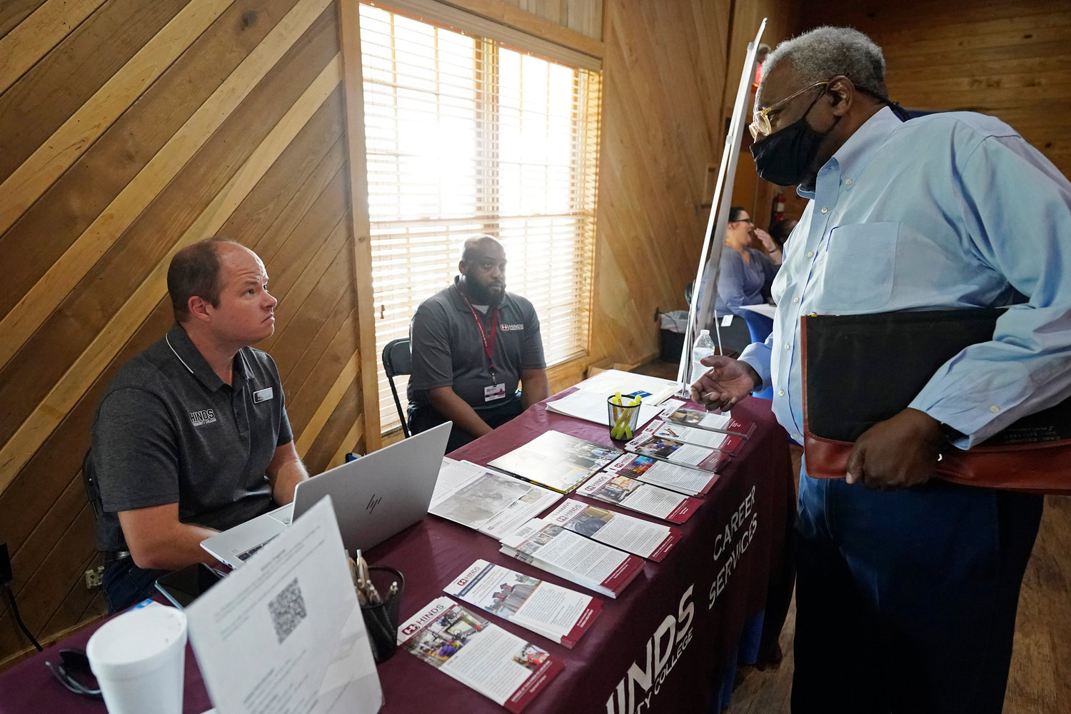 Robert Allen, director of work based learning, left, and Rod Mallett, work based learning coordinator, center, at Hinds Community College, discuss programs and opportunities with a job seeker, right, during the Mississippi Re-Entry Job Fair, in Jackson last month.