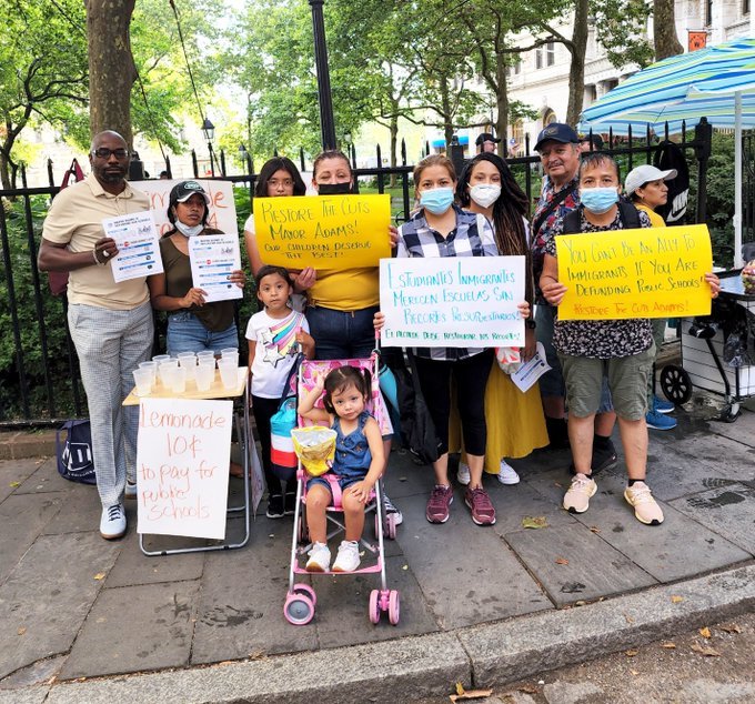 Families rallied against school budget cuts at City Hall July 28. The city comptroller's office found that the city has enough funds to reverse the school budget reductions, which are currently facing a legal challenge in Manhattan Supreme Court.