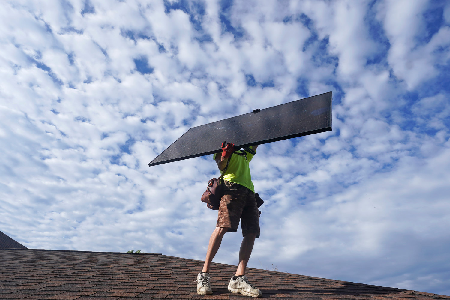 A workman from Power Shift Solar installed a solar panel in Salt Lake City earlier this month. The crux of the long-delayed but transformative climate change passed by Congress last week is to use incentives to accelerate the expansion of clean energy such as wind and solar power, speeding the transition away from the oil, coal and gas that largely cause climate change.