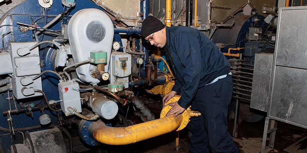 A worker at the city Housing Authority repairs a boiler. Although the HA has made strides in repairing elevators, and addressing rats and pests problems and other unsafe conditions, the number of heating outages has increased since 2019, the federal monitor charged with overseeing reforms reported.