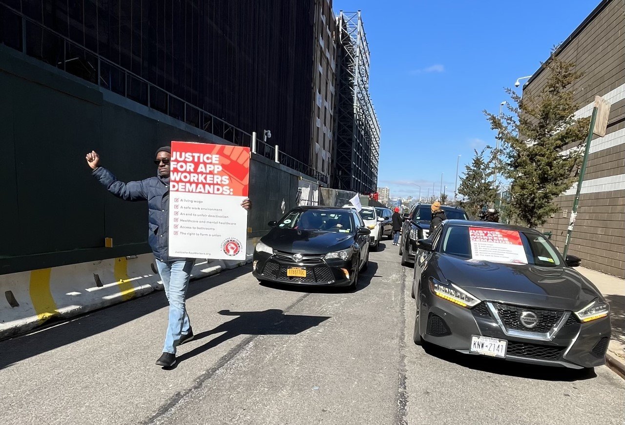 Gig workers, among them Uber and Lyft drivers, along a March 2022 caravan from Fort Greene, Brooklyn to Uber Headquarters in Manhattan during which they pressed for higher wages.