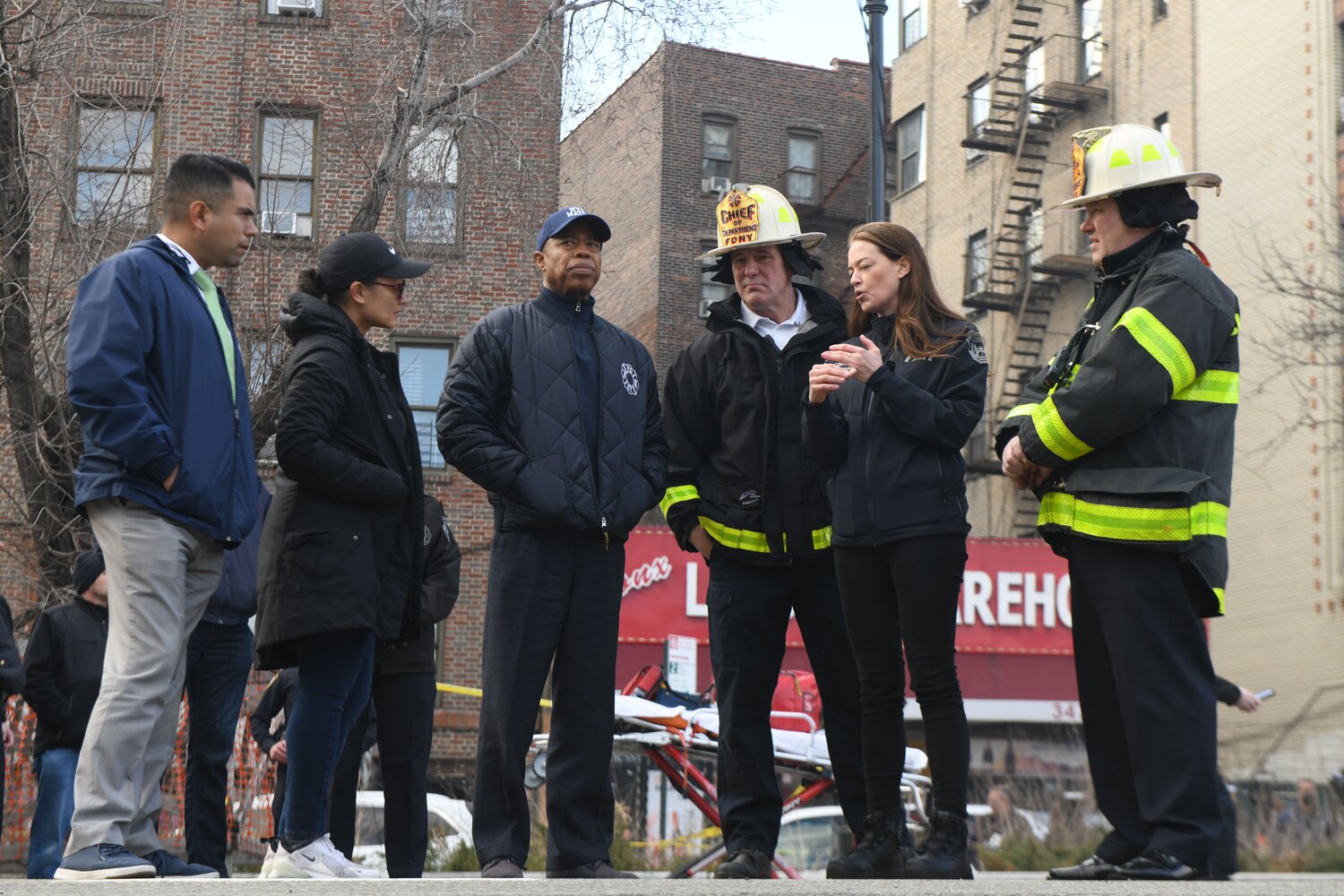 Mayor Eric Adams, FDNY Chief of Department John Hodgens and FDNY commissioner Laura Kavanagh confer following a five-alarm fire in the Bronx caused by a lithium-ion battery attached to a scooter. Firefighters battled the fire for hours and prevented it from spreading to nearby businesses after a battery exploded. Seven people, including five firefighters, were injured