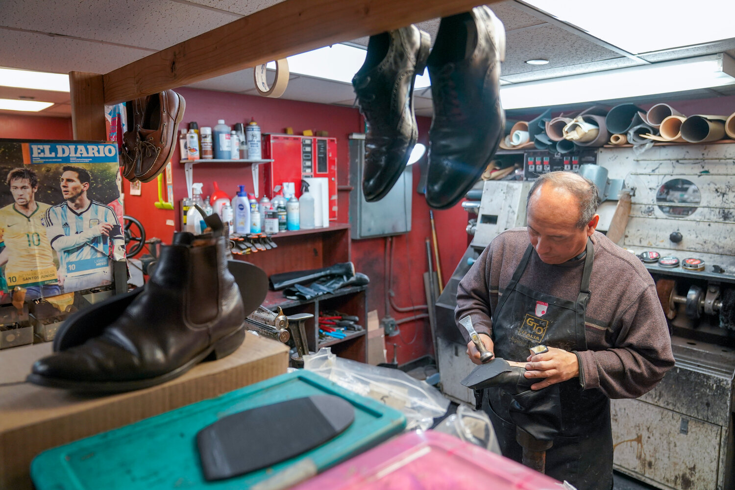 Repairing a pair of women's shoes at Alpha Shoe Repair at the Port Authority Bus Terminal. Shoe repairs typically bring in more money than shines.