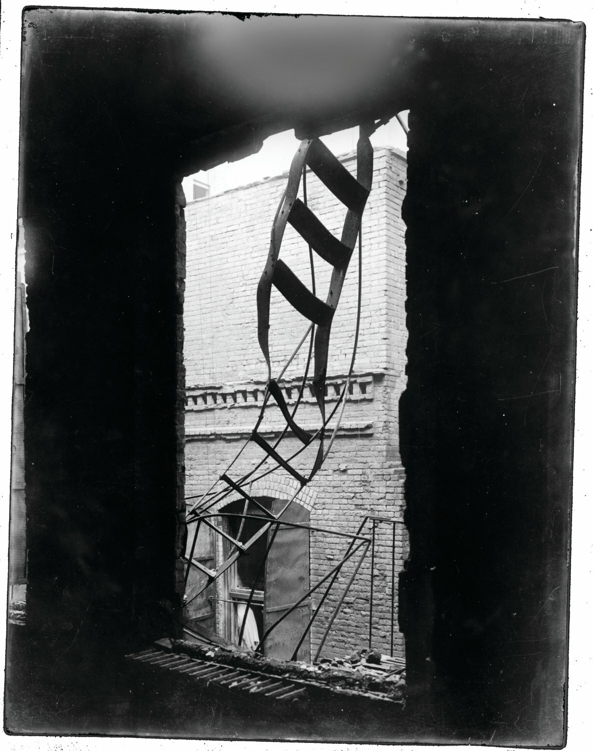 The twisted remnants of a fire escape alongside the Triangle Shirtwaist Factory on Washington Place following the March 25, 1911 fire that killed 146 garment workers.