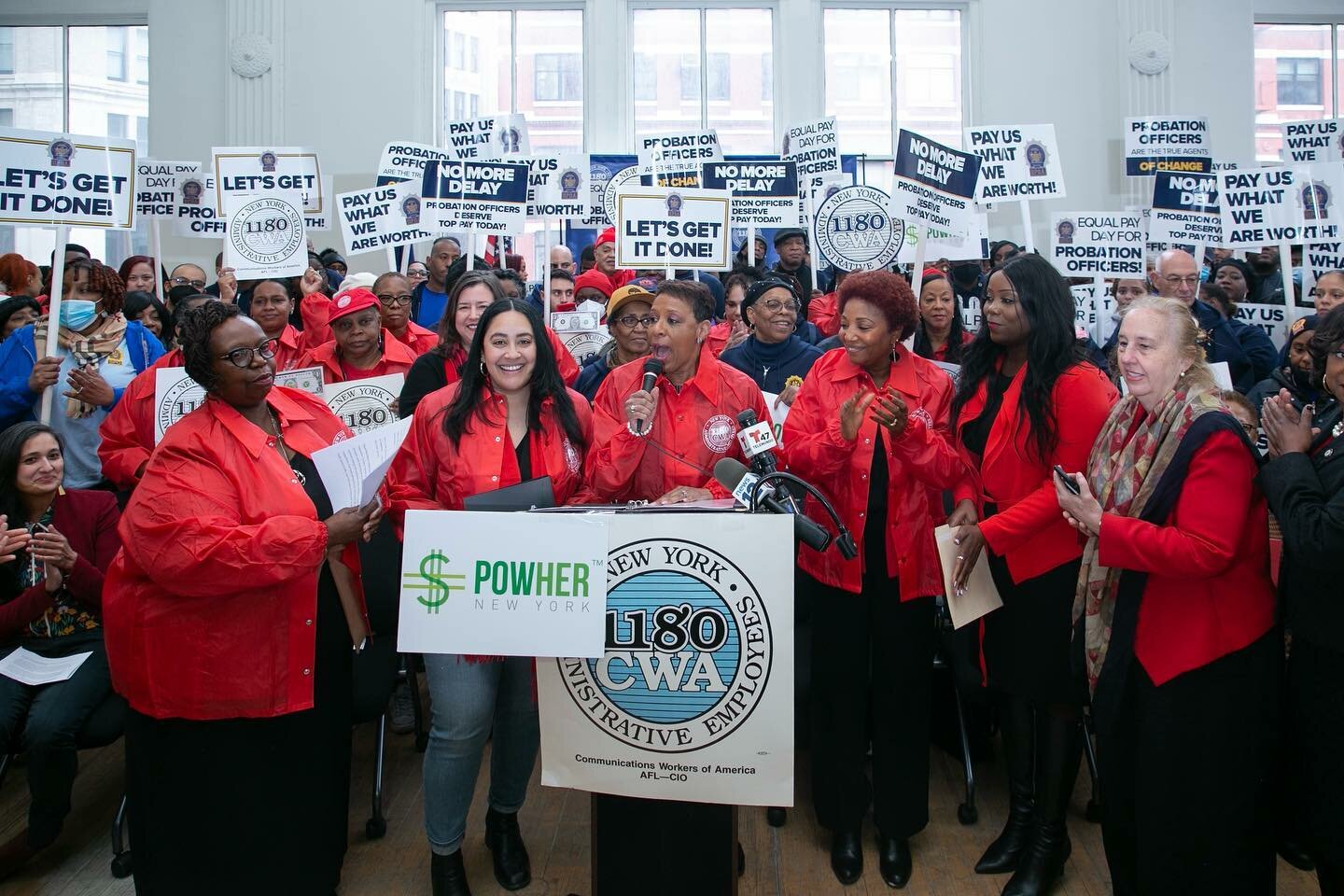 Members of the City Council's women's caucus, including Speaker Adrienne Adams (at mic) and Communications Workers of America Local 1180 members rallied at the union's headquarters March 14, or Equal Pay Day, to call for an end to the gender wage disparity. Although a report released by the Governor's office shows New York has narrowed the wage gap, pay for women of color still lags significantly behind white men.