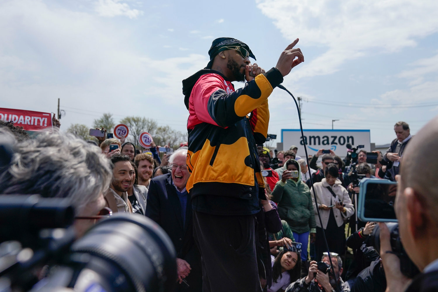 Christian Smalls, president of the Amazon Labor Union, spoke at a rally outside a Staten Island Amazon facility in the aftermath of a hard-won labor victory. Amazon workers cheered their victory and danced in celebration but their cheer is being tested by a company that will drive a hard bargain in contract negotiations.