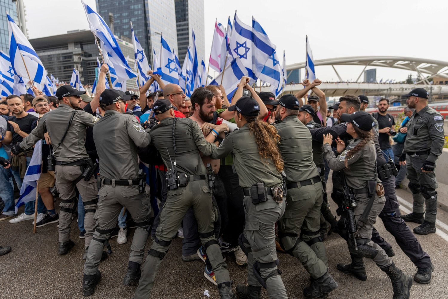 Israeli police scuffle with demonstrators blocking a road during a protest against plans by Prime Minister Benjamin Netanyahu's government to overhaul the judicial system in Tel Aviv, Israel, March 23.