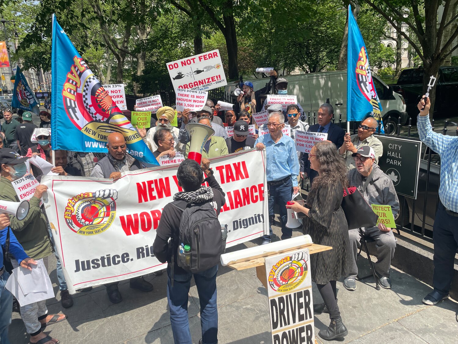 Members of the New York Taxi Workers Alliance, including its executive director, Bhairavi Desai, at right in the foreground, gathered May 11 outside the City Hall gates on Broadway to protest what Taxi and Limousine Commission pilot program that is expected to place 2,500 no-hail vehicles in the outer boroughs and northern Manhattan.
