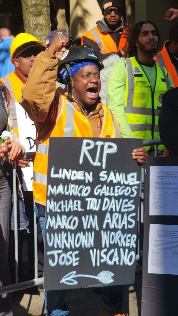 A construction worker held a sign with the names of laborers killed on the job. He and hundreds of construction workers rallied outside of the Fulton Street offices of Joy Construction to memorialize the workers and to highlight what they said was Joy’s poor treatment of its workers.