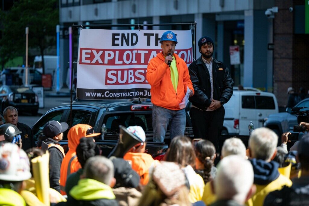 Steven Polizzi, a construction worker with Laborers’ Local 79, and Tafadar Sourov, an organizing field representative with the union, addressing a May 18 rally of construction workers outside the Fulton Street offices of Joy Construction.