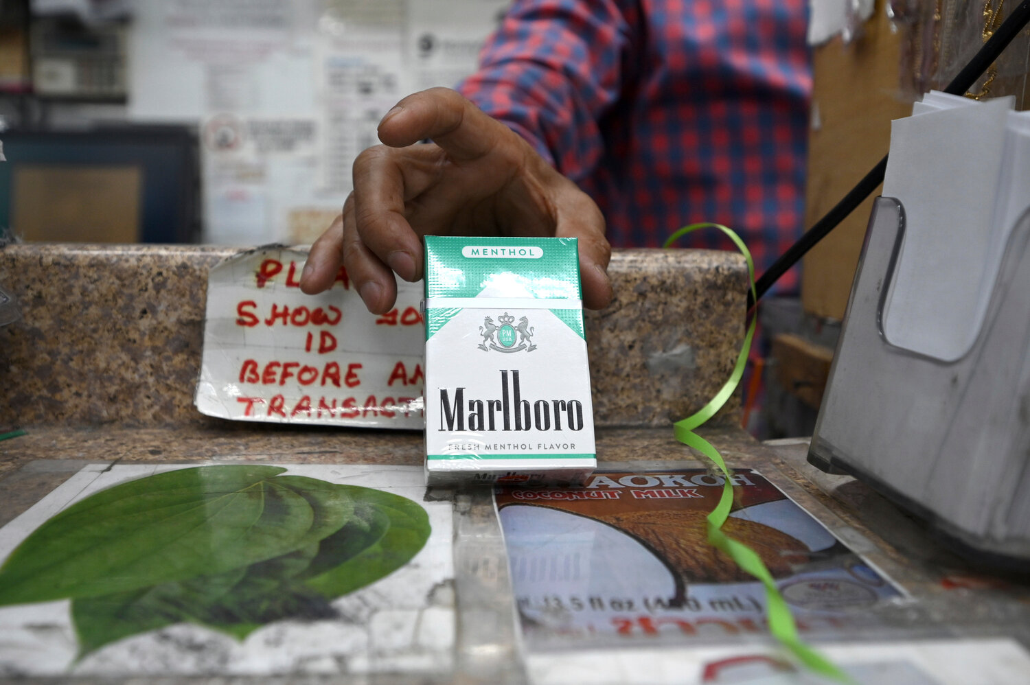 A Queens shopkeeper holds a pack of Menthol Marlboro cigarettes. The FDA announced it intends to ban menthol cigarettes due to higher rates of smoking-related illness and death in African-Americans communities. Our columnist argues the ban could pose unintended problems.