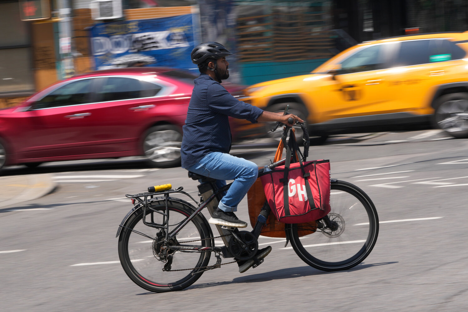 A delivery worker on a motorized bicycle coursed through the city in July. At least 10 states have also considered programs that would make it easier for gig workers to access traditional workplace benefits, such as retirement or paid family leave.
