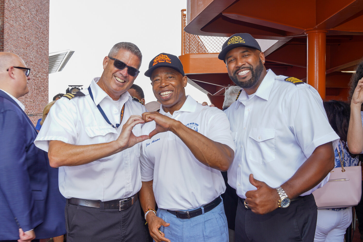 Mayor Eric Adams with two Staten Island Ferry crew members following the Sept. 4 announcement of a contract deal with the Marine Engineers’ Beneficial Association.