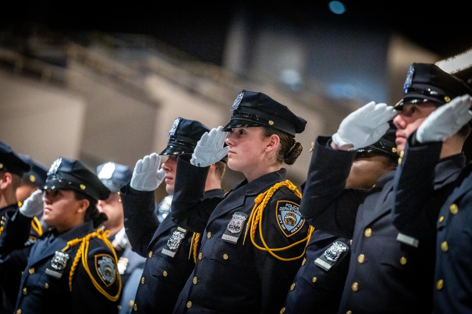 Police recruits at their graduation ceremony Oct. 30 at Madison Square Garden’s Hulu Theater. The 390 graduates will be among the last to join the department in at least 18 months following the announcement that the city has canceled five police academy classes. To address a growing budget gap, municipal agencies are cutting nearly 2,900 unfilled positions, moves denounced by District Council 37, the largest union representing city workers.