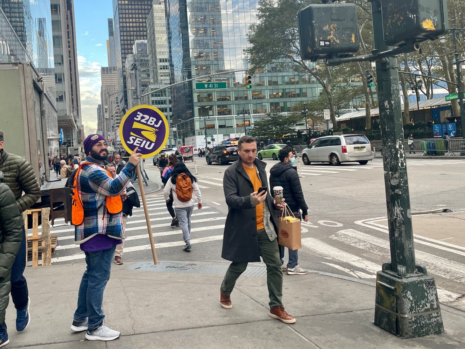A member of 32BJ of the Service Employees International Union on Sixth Avenue earlier this month following a Midtown rally by hundreds of the workers in support of raises and the retention of health benefits as contract negotiations with the Realty Advisory Board on Labor Relations come to a head.