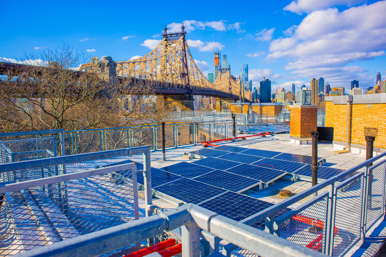 Rooftop solar arrays on a Queensbridge Houses New York City Housing Authority building. A coalition of dozens of labor, community, environmental and business organizations is pushing for the state to allocate $1 billion budget for climate projects built mainly by union labor.