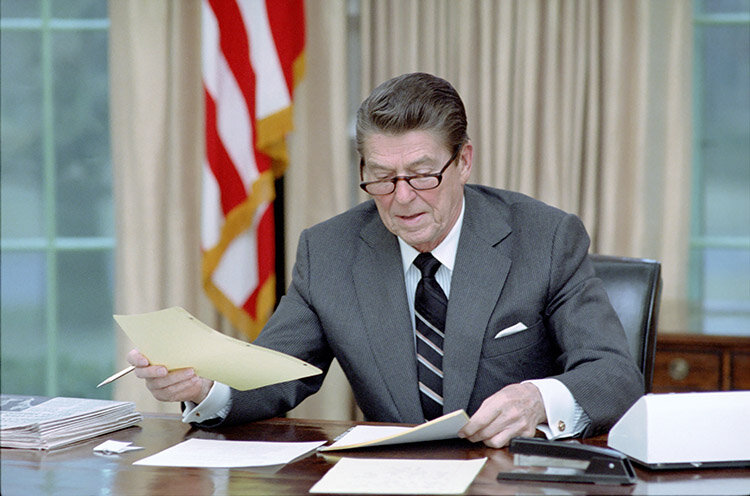 President Ronald Reagan worked at his oval office desk on his first full day as president, Jan. 21, 1981.