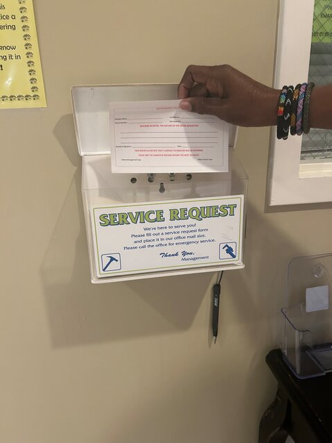 A person holds up a work order slip.