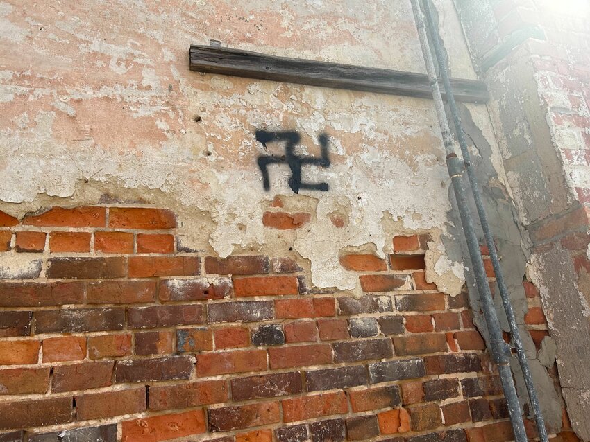 One of several swastikas included in the graffiti.