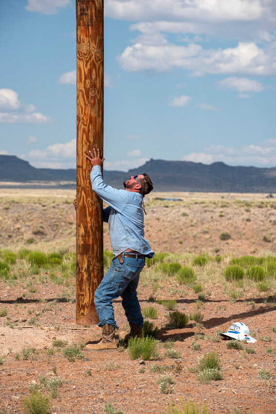 One lineworker carefully handles a pole while installing electricity in the Arizona-portion of the Navajo Nation. PWC employees described the process as intense and requiring precision. 