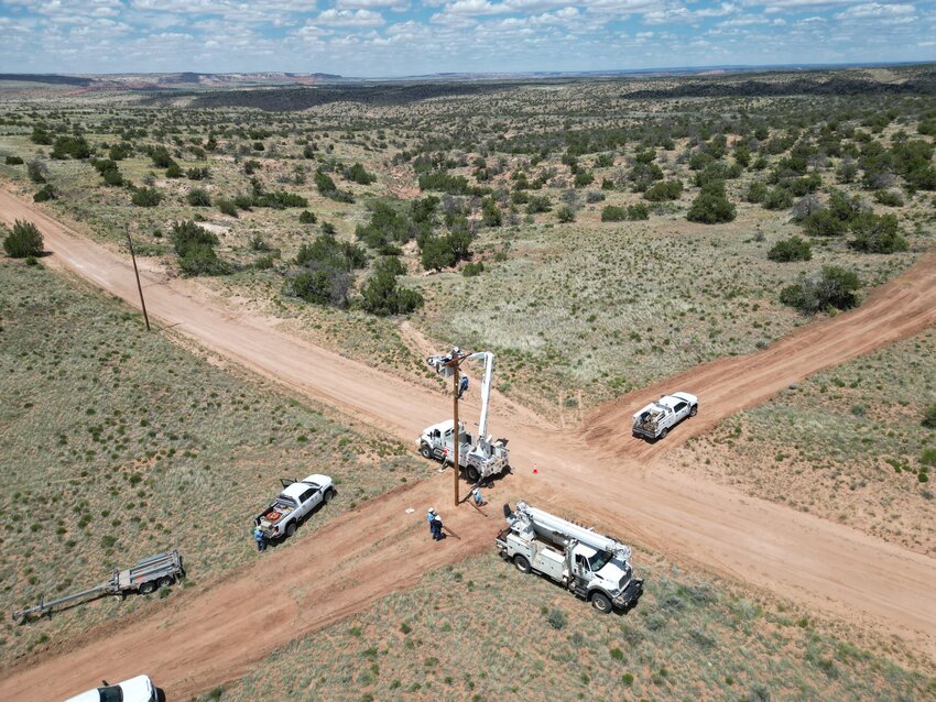 Crew members from PWC set up power lines in a rural area of the Navajo Nation.