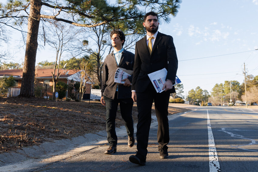 Zach Traylor (right), who wants to run in the 2024 election for state House Dist. 44, and his campaign manager Kenny Rouge walk door-to-door in Fayetteville on Tuesday, Jan. 30, 2024, as they attempt to collect 2,170 signatures from voters in the district. State law says that as an independent candidate — one who is not a member of a political party — Traylor can't be on the ballot unless 2,170 voters sign his petition by noon, March 5, 2024.