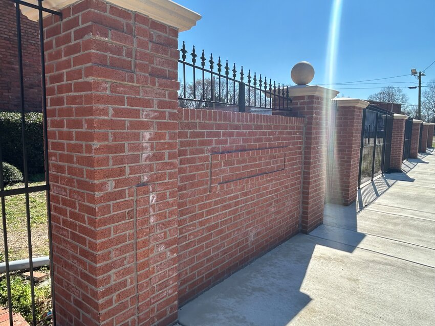 The brick fence to the school.