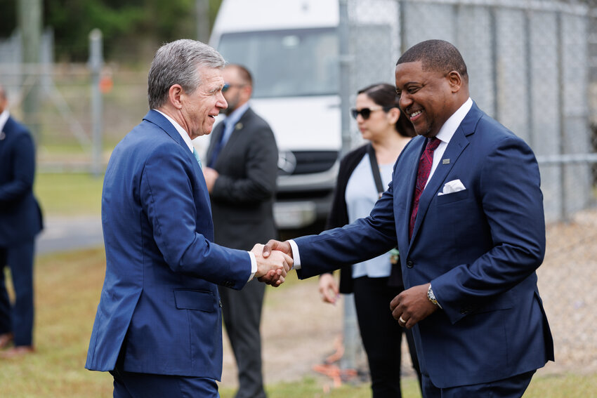 Mayor Mitch Colvin (R) greets Governor Roy Cooper as he arrives for the  EPA press conference at the Hoffer Water Treatment Facility on April 10, 2024.