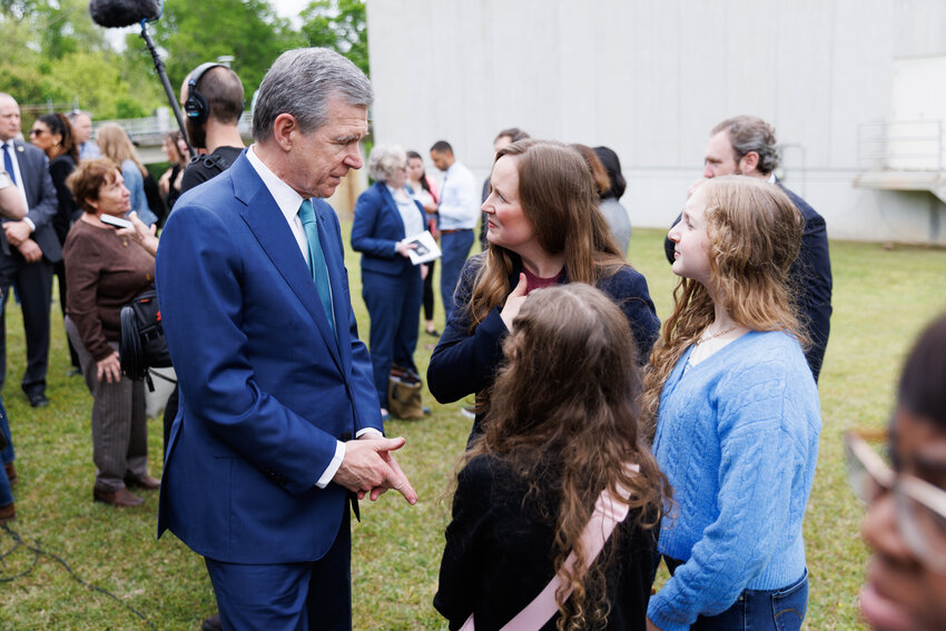 Katie Bryant (R), co-founder of Clean Haw River in Pittsboro, NC, and her daughters London and Berlin speak with Governor Roy Cooper following the EPA press conference at the Hoffer Water Treatment Facility on April 10, 2024. Photo: Tony Wooten