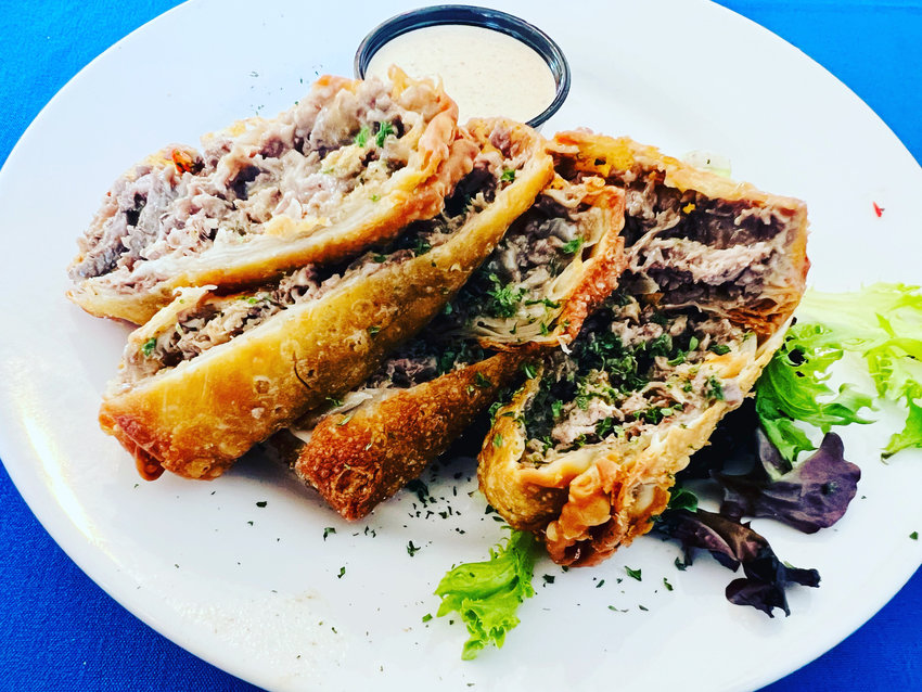 Ribeye-stuffed eggrolls are served with avocado ranch at Manning’s Restaurant in downtown Clayton.