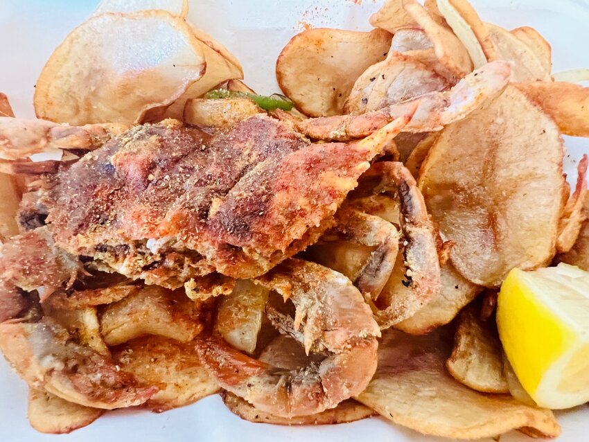 Soft-shell crab is served with wafer-thin fried potatoes at Saltbox Seafood Joint in Durham.