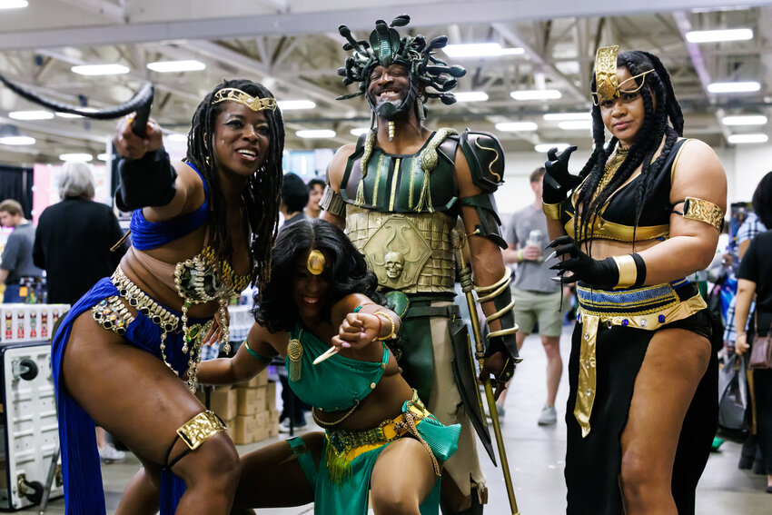 Dressed as Cobra villain Mandusa III, Delvecchio Coleman is protected by bodyguards (from left) Tashoya Smith, Kandice Jackson, and Venesia Biggy during Saturday's Comic Con at the Crown Complex.