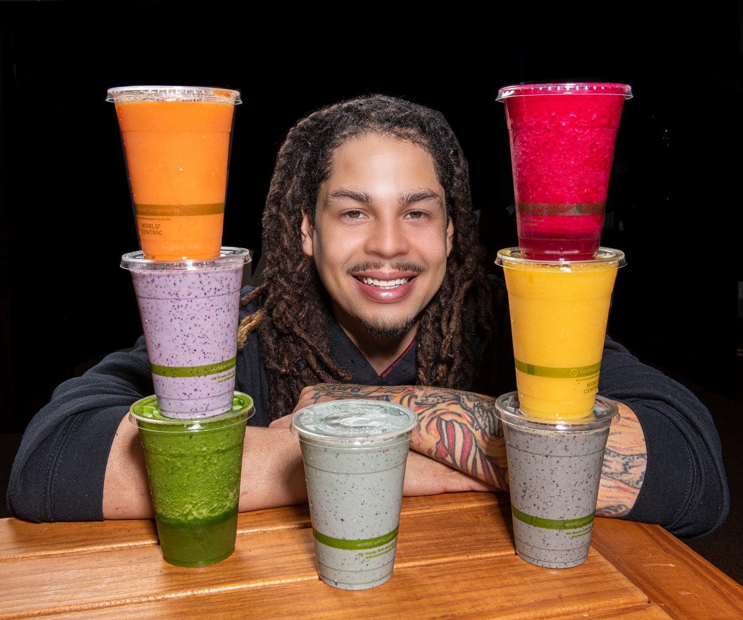 Adrian Burgos with a  rainbow of smoothies and energy drinks have names such as Mellow Mango, Rock The Beet, Green With Envy, and Berry The Hatchet...Prima Elements Holistic Wellness Center.on Anderson Street in downtown Fayetteville