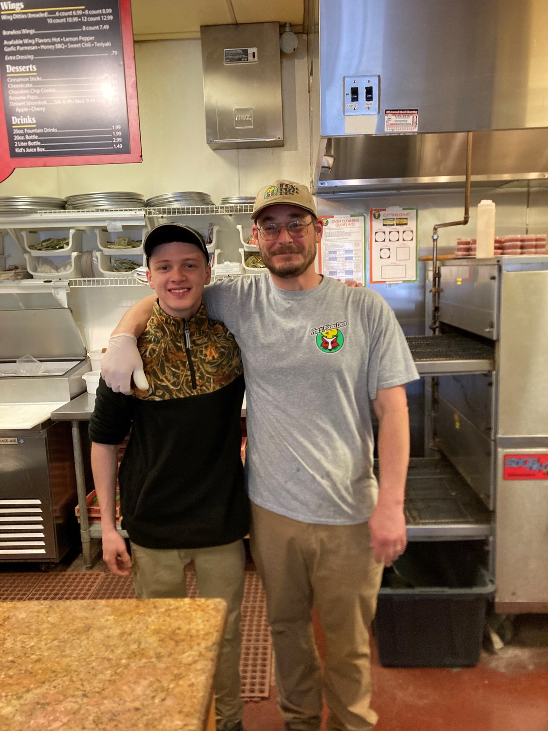 Front counterman Noah Godbold and manager Josh Welker greet customers at Fox’s Pizza Den at 3941 Dunn Road in Eastover.