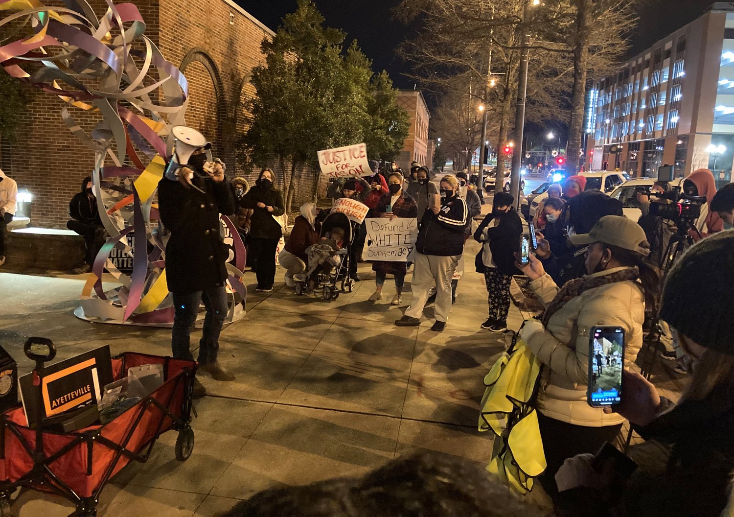 As the Fayetteville Ethics Commission heard complaints against Police Chief Gina Hawkins on Tuesday, people gathered outside City Hall to protest the shooting Saturday of Jason Walker.