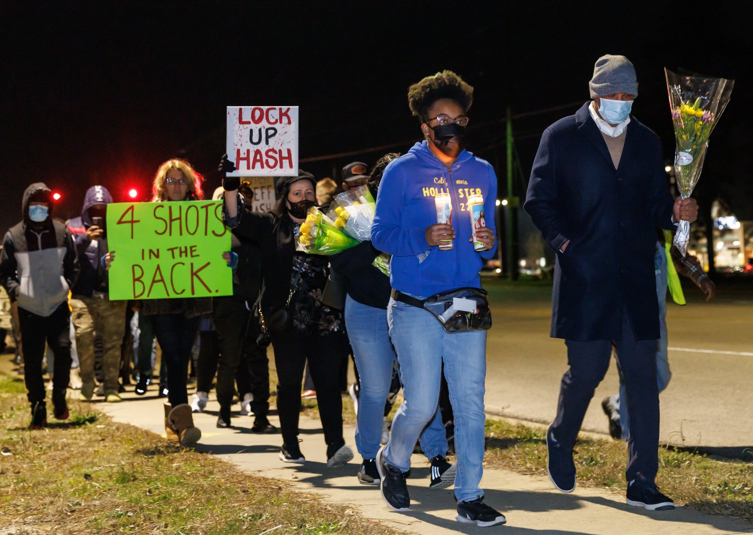 People march Wednesday night on Bingham Drive to protest the shooting of Jason Walker.