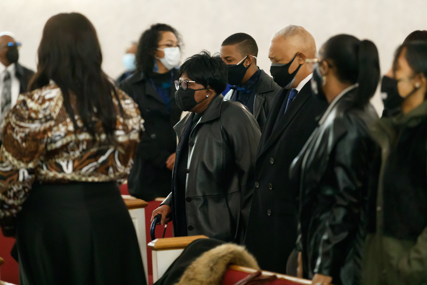 Jason Walker's father, Anthony Walker, his mother,  Janice Walker, and his son, Christian Heywood, walk to their seats before Walker’s funeral Friday.