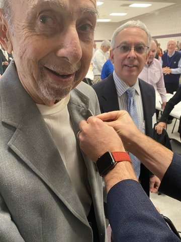 Marty Sternlicht receives his Kiwanis International 50-year Legion of Honor pin on Dec. 17 from Worth Smith, president of the Kiwanis Club of Fayetteville. Son Mark Sternlicht looks on.
