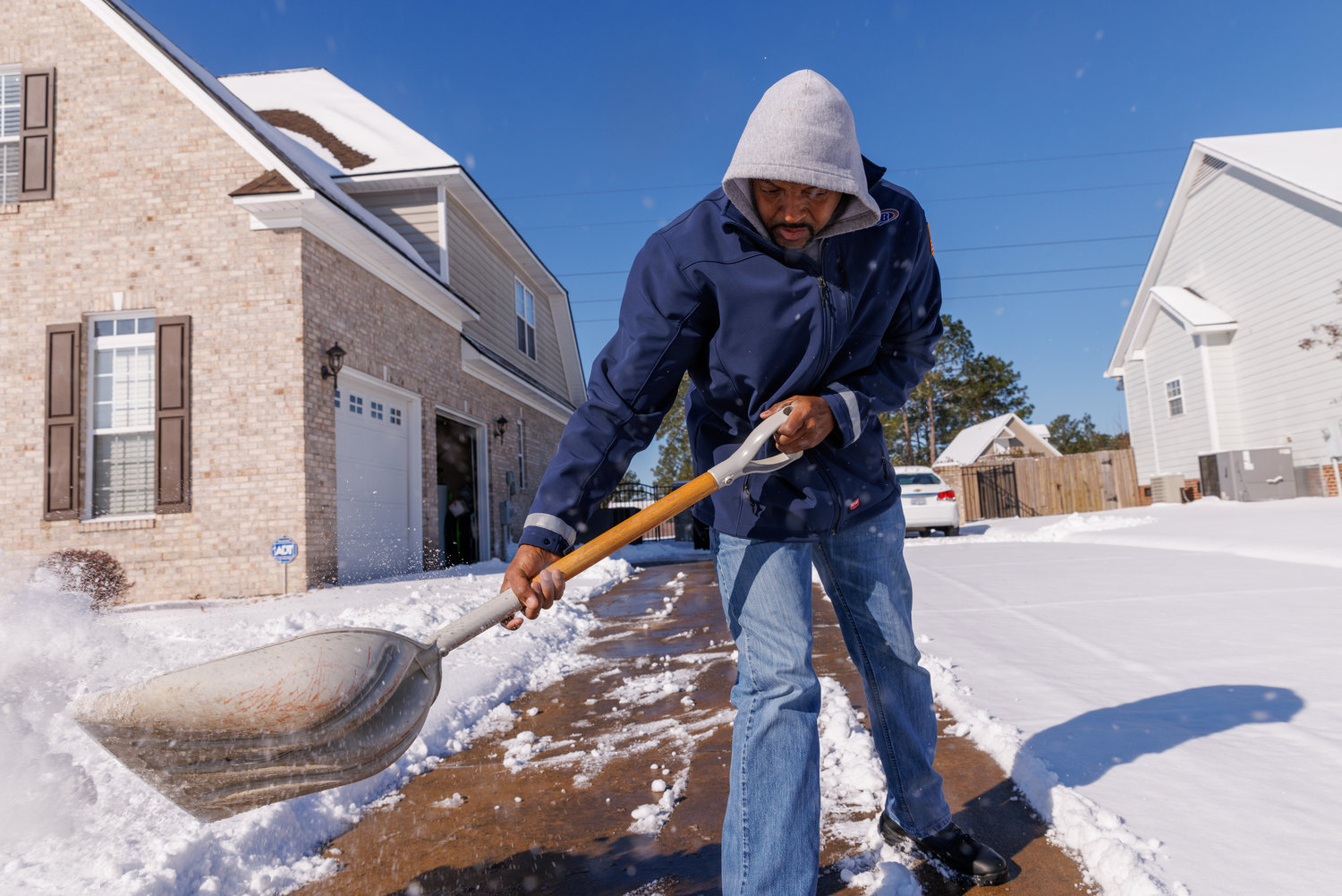 Darick Stevens shovels snow from his driveway in Hope Mills on Saturday. A winter storm brought 4 inches of snow to Hope Mills, the National Weather Service said.